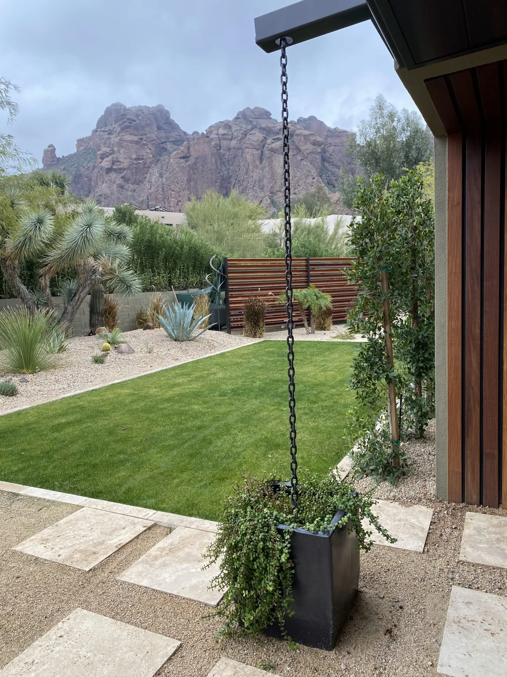 A serene backyard with green grass and mountain views.