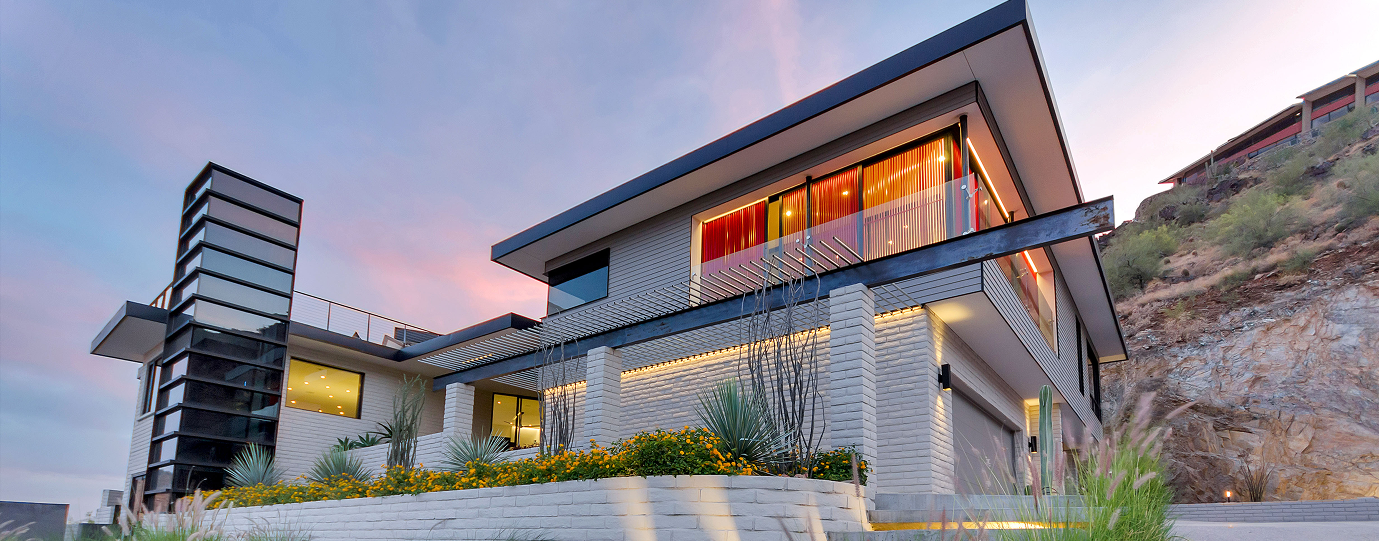 Modern hillside home at sunset